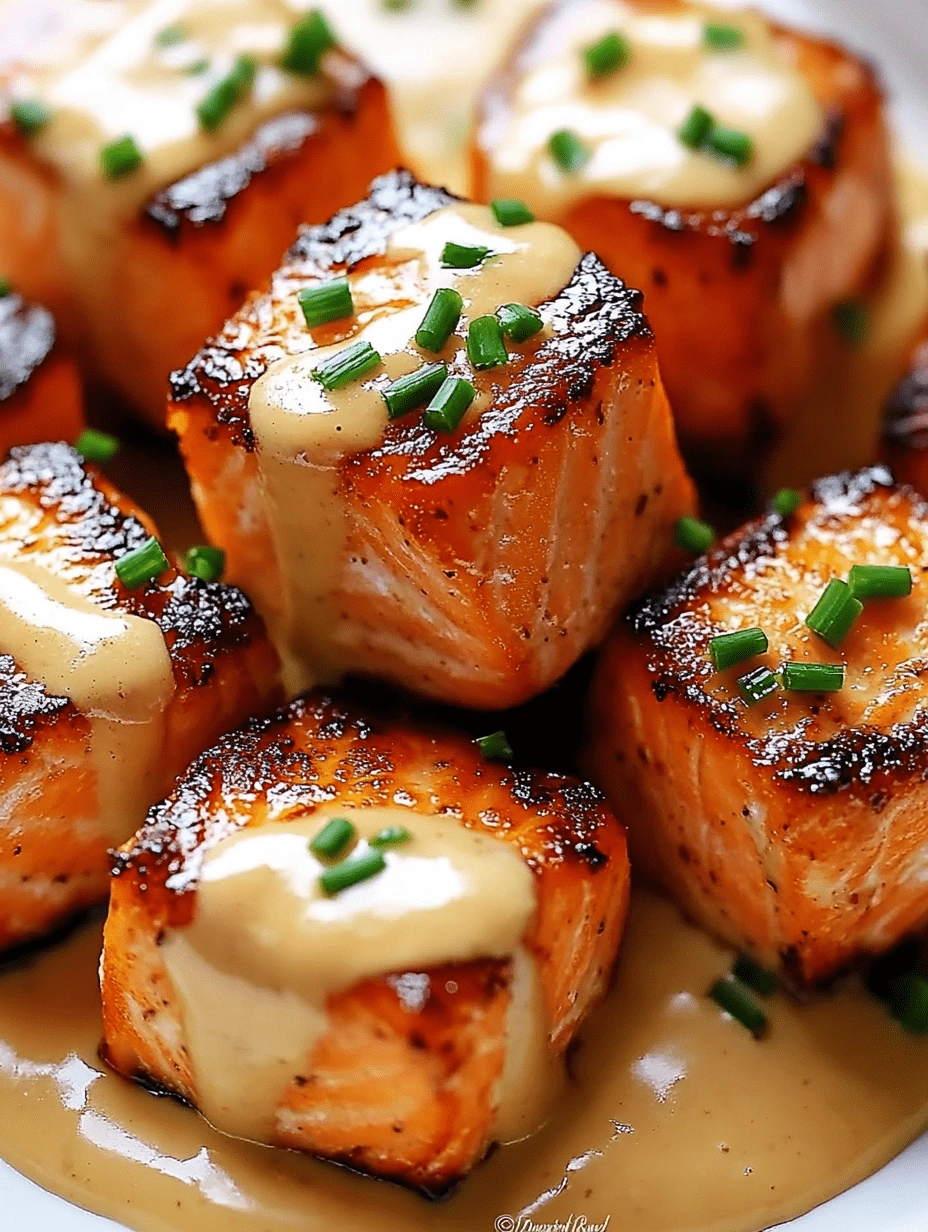 crispy-salmon-bites-bang-bang-sauce-drizzle Crispy salmon bites stacked and topped with Bang Bang sauce and fresh chives
